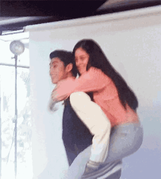 a woman is carrying a man on her back