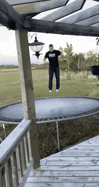 a man is jumping on a trampoline wearing a shirt that says ' x-men '