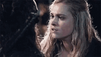 a close up of a woman looking at a man 's face .