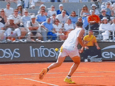 a man playing tennis on a court with a sign that says infosys