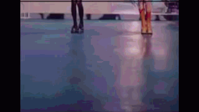 a person is rollerblading on a blue floor