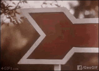 a red and white sign with a sigma symbol on it
