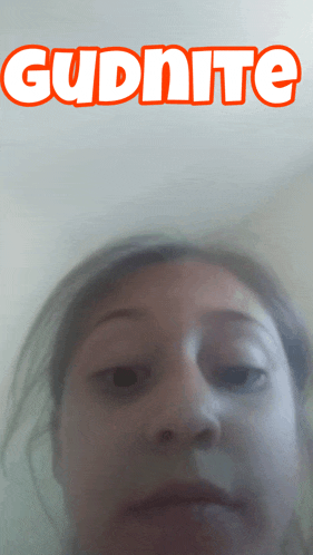 a close up of a woman 's face with the word gudnite above her head