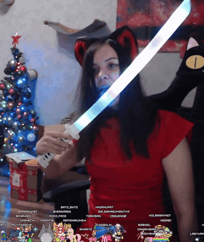 a woman in a red shirt holds a light up sword