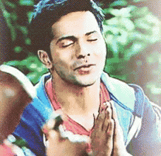 a man is praying with his eyes closed and his hands folded in front of him .