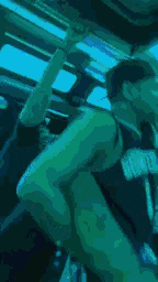 a person sitting in a car with a green light behind them