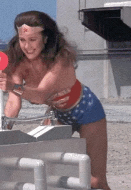 a woman in a wonder woman costume is smiling