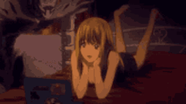 a girl is laying on her stomach on a bed with a skeleton behind her .