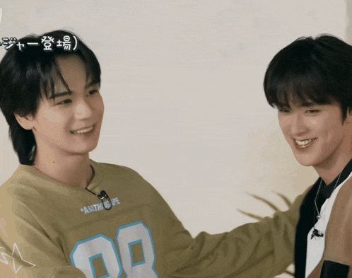 two young men are hugging each other and one has a shirt with the number 08 on it