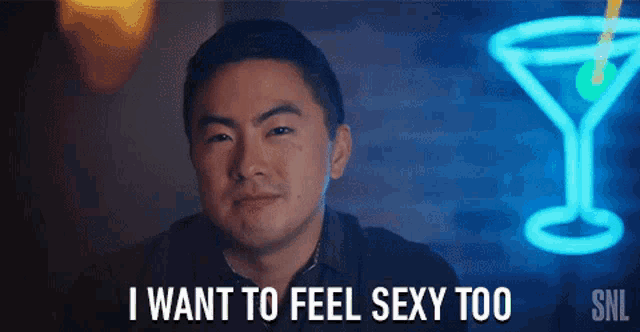 a man says i want to feel sexy too in front of a neon sign