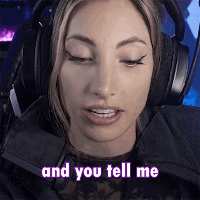 a woman wearing headphones says " and you tell me " in pink