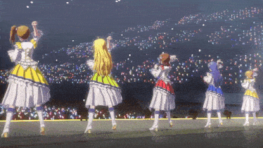 a group of girls are dancing on a stage in front of a crowd