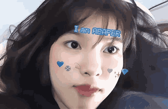 a girl with a sticker on her face that says " i am abaper "