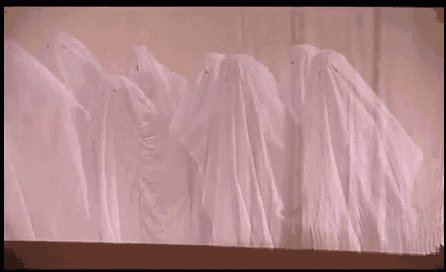 a group of ghosts are standing in a row