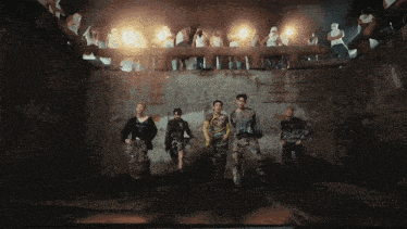 a group of people standing in a dark room