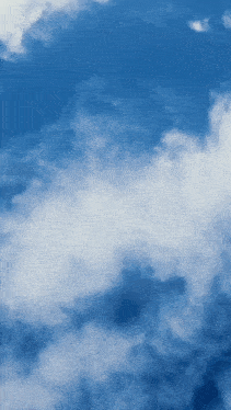 a blue sky with white clouds floating through it