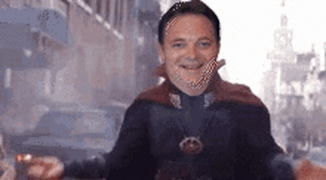a man in a superhero costume is smiling in front of a city street