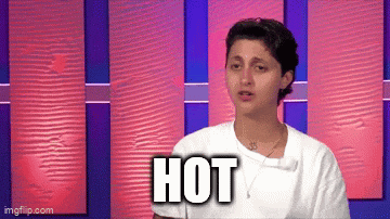 a woman in a white shirt is standing in front of a pink and purple wall with the word hot written on it .