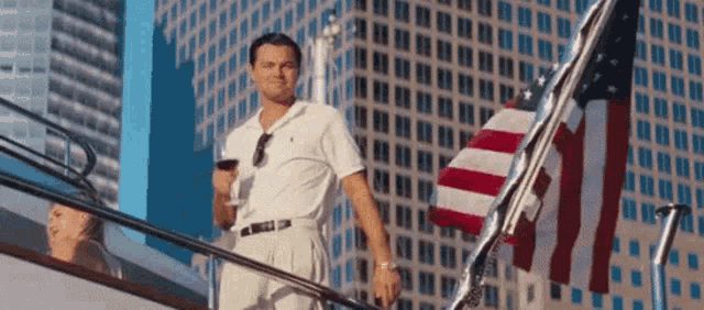 a man standing on a boat holding a glass of wine
