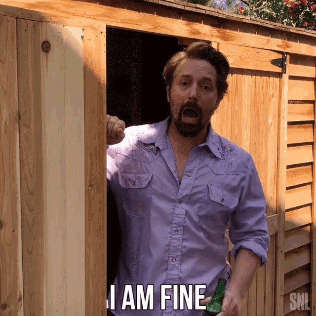 a man in a purple shirt is holding a bottle of beer and says " i am fine "