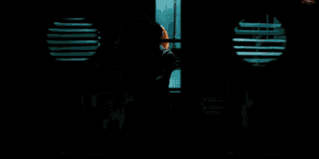 a pixelated image of a man standing in front of a door with a sign that says no smoking