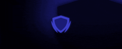a blue flame is floating in the dark on a black background .