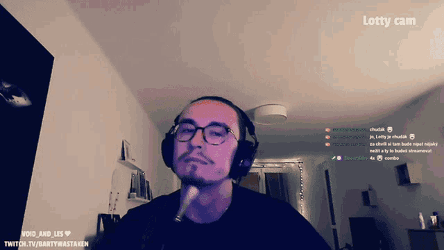 a man wearing headphones and a microphone with the words lotsy cam on the top