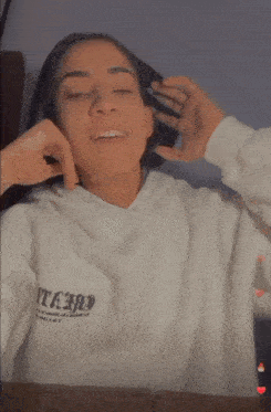 a woman wearing a white shirt that says eternal on it