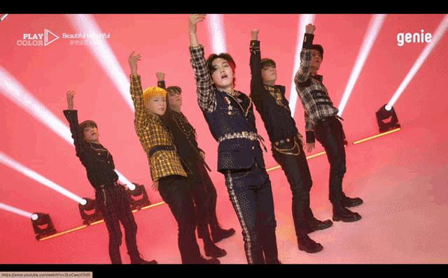 a group of young men are dancing in front of a red background that says " play color "