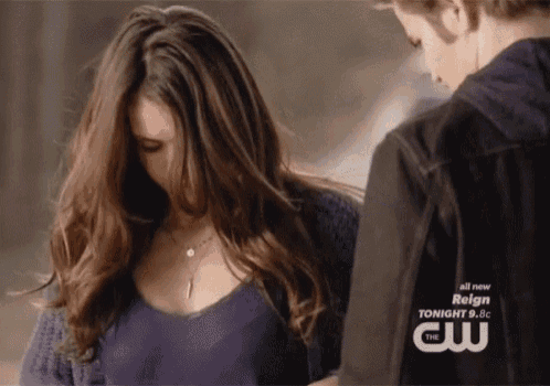 a man and a woman are standing next to each other with reign written on the bottom of the screen