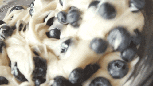 a close up of a bowl filled with blueberries and batter