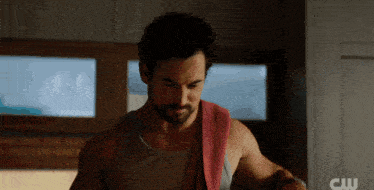 a man with a towel around his neck has the letters cw on the bottom right