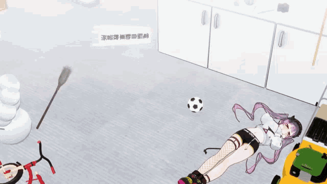 a girl laying on the floor with a soccer ball and a broom