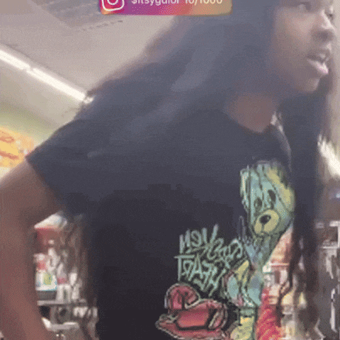 a woman with long hair is wearing a black shirt that says " mou " on it
