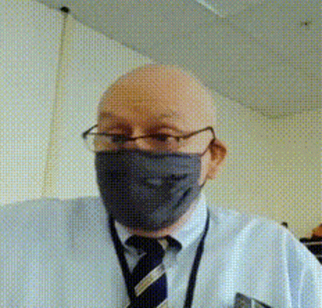 a man wearing a face mask and glasses