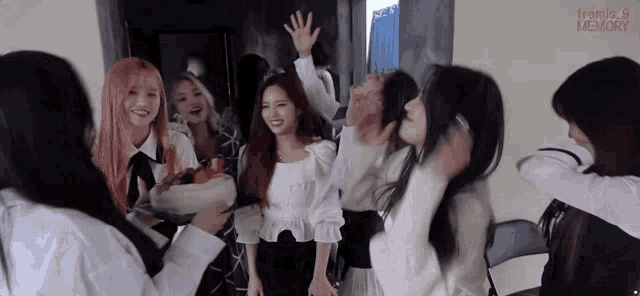 a group of girls are standing next to each other in a room .