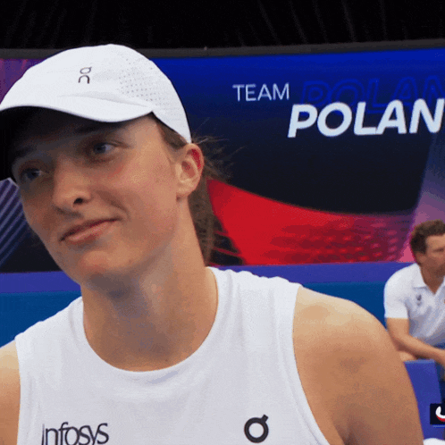 a woman wearing a white tank top with the word infosys on the side