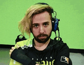 a man with a beard wearing headphones and a shirt that says duson on it