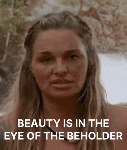 a close up of a woman with the words beauty is in the eye of the beholder below her