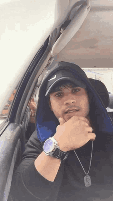 a man wearing a nike hat and a watch