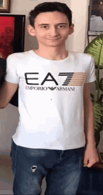 a young man is wearing a white emporio armani shirt