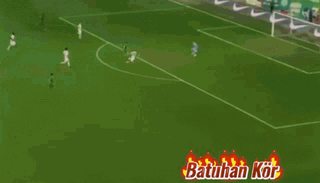 a blurred image of a soccer player with batuhan kor written on the bottom right