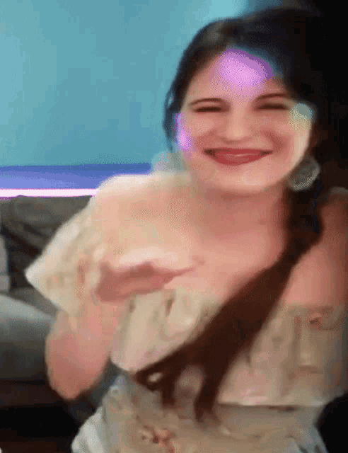 a woman in a white dress is smiling and holding a cup