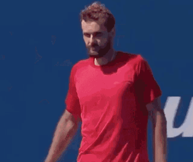 a man in a red shirt is clapping his hands