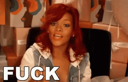 a woman with red hair is sitting in a chair with the word fuck above her .