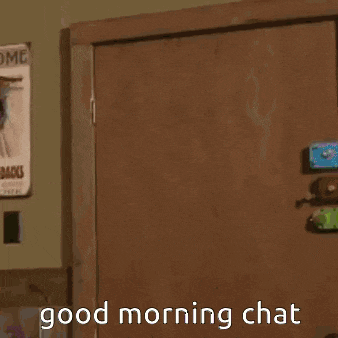 a man in a green suit is standing in front of a door and says good morning chat .