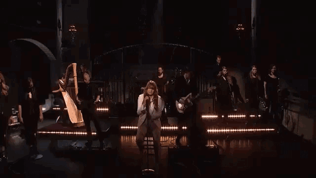 a group of people playing instruments on a stage