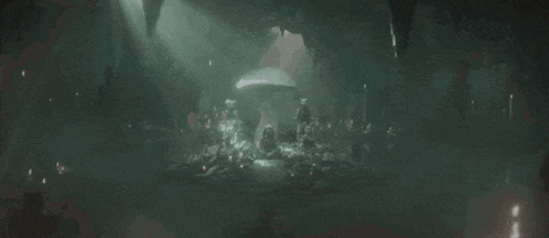 a dark cave with a mushroom growing out of the ground