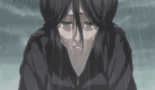 a woman is crying in the rain with tears running down her face .