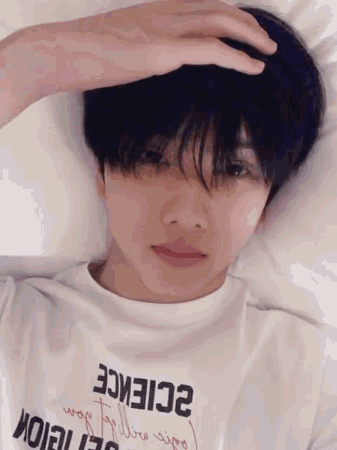 a young man wearing a white shirt that says science on it